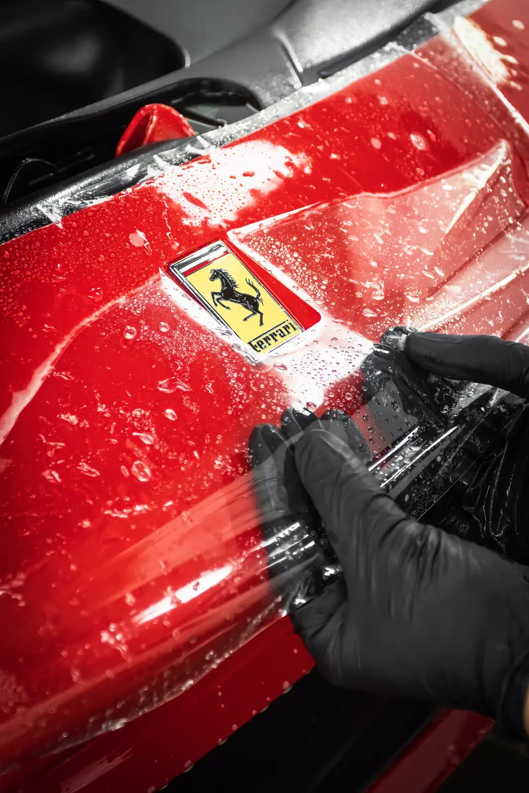 Ferrari lettering on a wing covered with protective film.